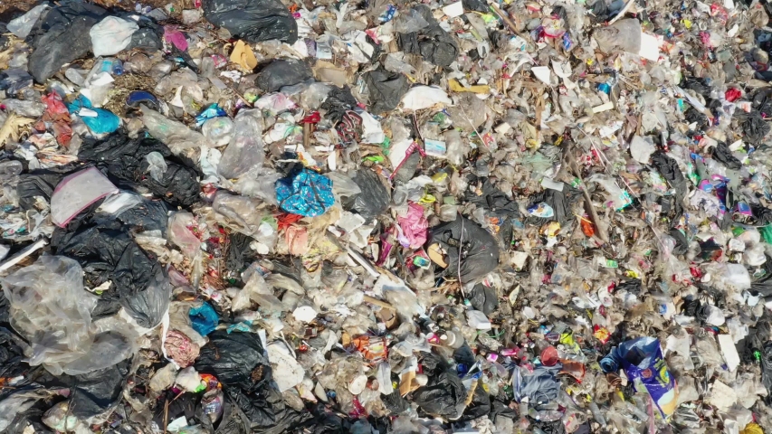 Plastic pollution environmental problem. A landfill filled with trash which is not recycled. Aerial drone video | Shutterstock HD Video #1046886979
