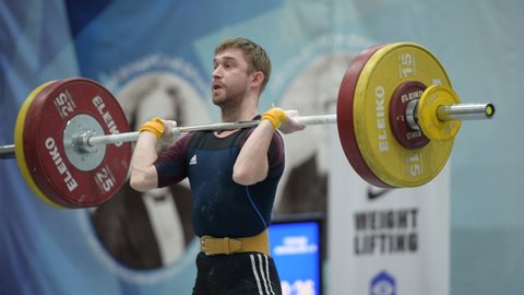 ST. PETERSBURG, RUSSIA - FEBRUARY 4, 2020: Gennady Zykov competes in clean and jerk among men under 55 kg during Russian Weightlifting Cup. Zykov won the Cup this year