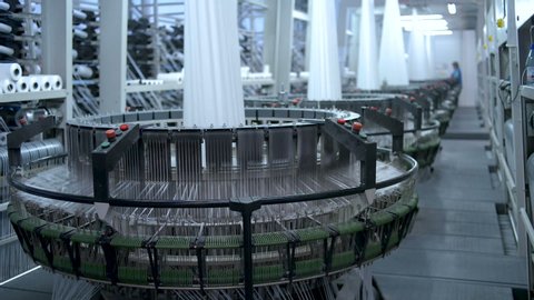 Modern large high-speed circular looms in workshop, concept of manufacturing textiles 