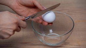 cropped view of man breaking egg in bowl