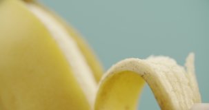 Macro peeling of banana. Slow motion video