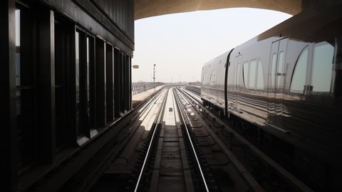 Metro train passing by side in opposite direction, metro is the most fastest and economical way of transportation in Doha, Qatar -02/19/2020