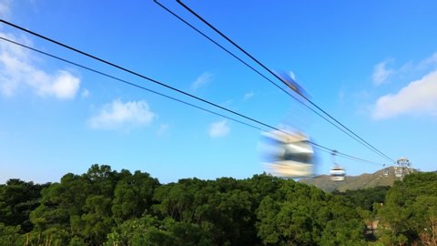 TIME LAPSE: Scenic view of the Cable Car in Lantau Island, popular Chinese religious destination for Tian Tan Buddha temple. Hong Kong, China.