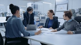 Modern Factory Office Meeting Room: Multi Ethnic and Diverse Team of Engineers, Managers and Investors Talking Sitting at Conference Table, Searching Solution for High-Tech Manufactory Optimization - Powered by Shutterstock - Get 15% off with code: PIKWIZARD15