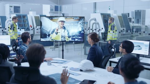 Diverse Group of Specialists, Managers in the Factory Office Meeting Room, Have Conference Video Call with Factory Chief Female Engineer, She Talks about Production Growth, Uses Tablet Computer