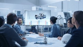 Modern Factory Office Meeting Room: Diverse Team of Engineers, Managers and Investors Talking at Conference Table, Watching Interactive TV that shows Sustainable and Renewable Green Energy Engine - Powered by Shutterstock - Get 15% off with code: PIKWIZARD15