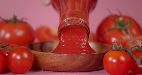 Fresh tomato sauce. Pour tomato ketchup from a glass bottle.