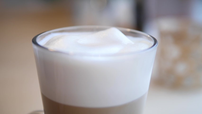Scooping Thick Foam Of A Delicious Hot Coffee Latte With A Spoon In A Glass. | Shutterstock HD Video #1046910547