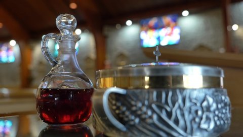 Wine and Eucharist in church on table