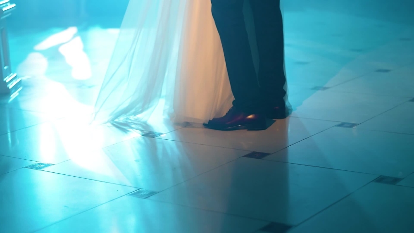 Feet of bride and groom dancing at restaurant