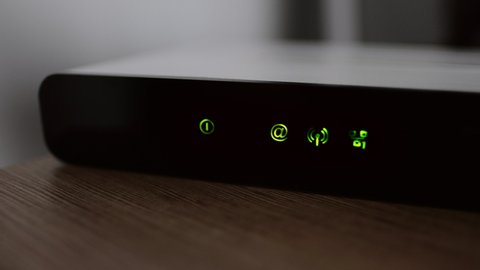 Working wifi router with lights and internet connection status.