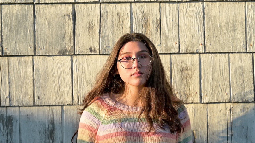 Young teen girl lookin into camera portrait style