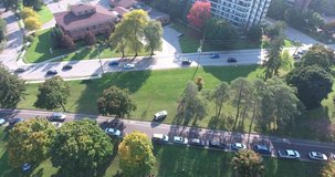 Traffic on Road Beside Park and Apartment Buildings Drone Aerial View 002