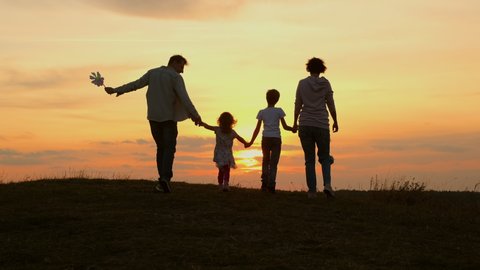 Family Vacation In Nature. Young Mom, Dad And Their Daughters And Son Meet At Sunset.