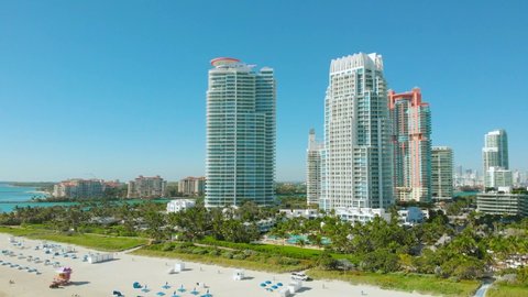 Miami Beach on a bright sunny day, aerial view. Drone flying forward near Miami Beach, South Beach, Florida. Cinematic video of a luxury resort in Miami South Beach. Holidays in Miami Touristic City.