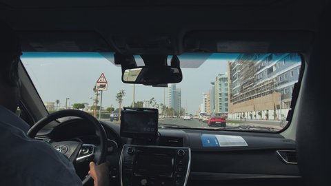 Dubai, UAE - December 14, 2019: View from the cab of a car taxi to the streets of Dubai.
