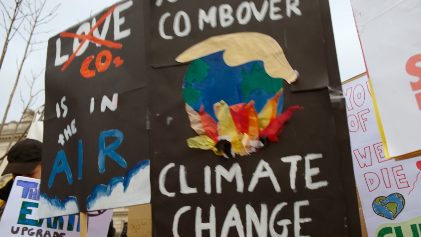 Close-up of a poster during a School Strike for Climate organized by students in Westminster and Downing Street, London, UK Royalty-Free Stock Footage #1046947642