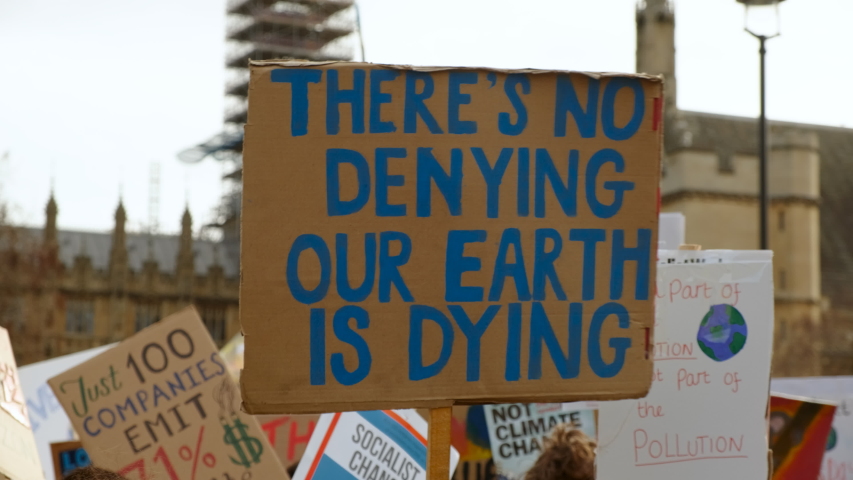 Close-up of a poster during a School Strike for Climate organized by students in Westminster and Downing Street, London, UK Royalty-Free Stock Footage #1046947663