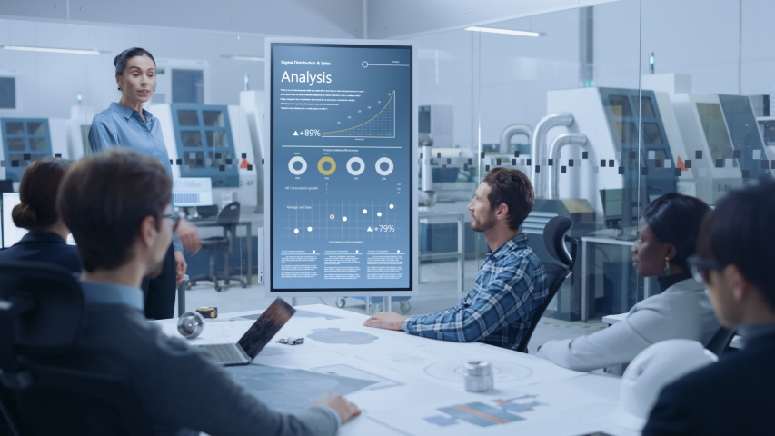 Modern Industrial Factory Meeting: Confident Female Engineer Uses Interactive Whiteboard, Makes Report to a Group of Engineers, Managers Talks, and Shows Statistics, Growth and Analysis Information | Shutterstock HD Video #1046954200
