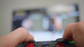 Close up of shot of man hand playing a gamepad in fighting