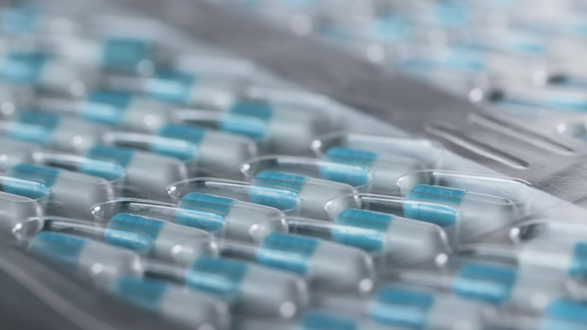 Manufacture of Drugs in Pills for Medical Supply of Pharma Industry. Filling Sterile Blister with Medication on Conveyor Line of Pharmaceutical Factory. Preparation and Production of Capsules Closeup Royalty-Free Stock Footage #1046960044