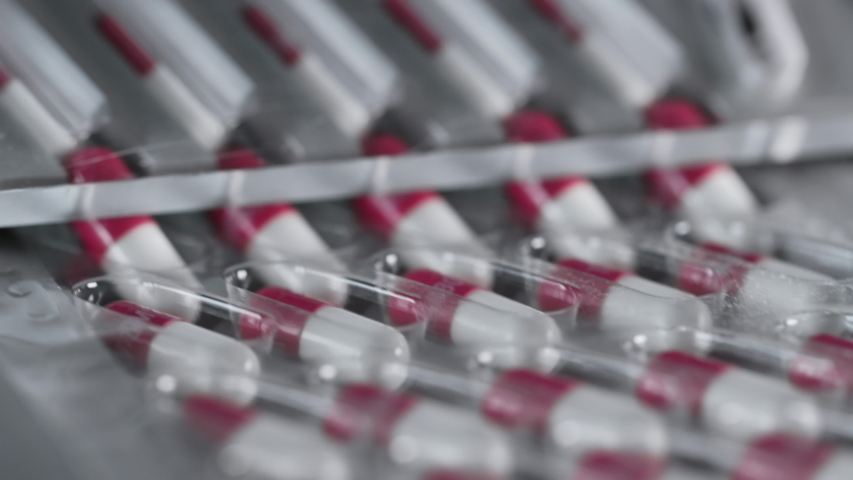 Manufacture of Drugs in Pills for Medical Supply of Pharma Industry. Filling Sterile Blister with Medication on Conveyor Line of Pharmaceutical Factory. Preparation and Production of Tablets Close-up | Shutterstock HD Video #1046960053