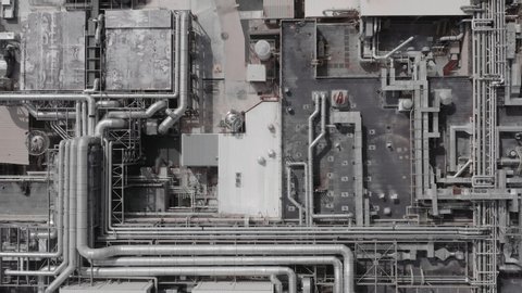 Aerial top down view of a futurisic technology manufacturing plant. Cinematic 4K establishing shot.