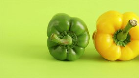 fresh colorful bell peppers on green  background panning shot 