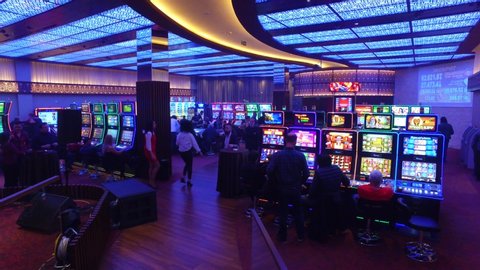 Batumi, Adjaria / Georgia - 01.13.2020: Modern casino hall with players. People play casino on slots.