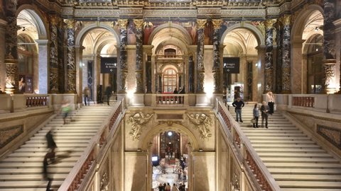 Vienna, Austria - November, 2019: Tourists sightseeing and people visiting Kunsthistorisches Museum (Art History) inside Ringstrasse building with sumptuous staircase in time-lapse.