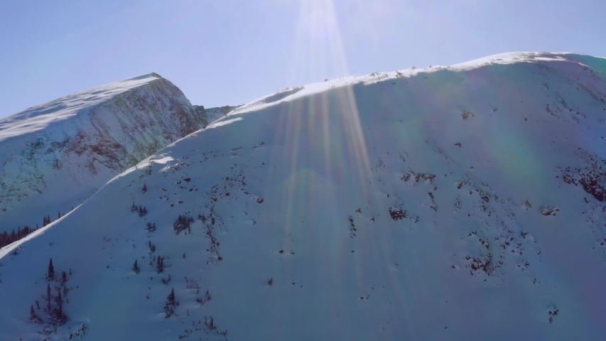 Epic rising aerial shot revealing mountains. Located in the backcountry of Breckenridge, Colorado, a part of the Rockies. Altitude is over 10,000 feet.