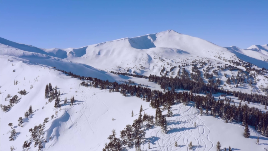 Aerial shot of backcountry ski tracks in mountains. Located in the backcountry of Breckenridge, Colorado, a part of the Rockies. Altitude is over 10,000 feet.