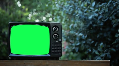 Vintage TV Set with Green Screen Outdoors. Zoom In. You can Replace Green Screen with the Footage or Picture you Want with “Keying” effect in After Effects (check out tutorials on YouTube).