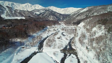 Mid winter in Hakuba valley Nagano Japan, ski, snowboard snow mountains drone aerial blue sky