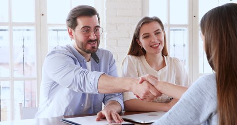 Satisfied hr recruit team managers handshake hire female candidate at job interview. Smiling employer shake hand of young intern seeker offering work professional contract, staff employment concept