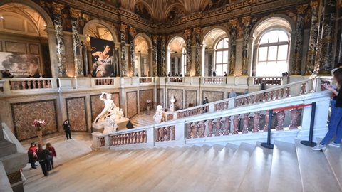 Vienna, Austria - Nov, 2019: Tourists sightseeing in Kunsthistorisches Museum of Art History interior with sumptuous staircase hall in time-lapse during Caravaggio and Bernini exhibition in daylight.