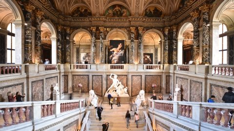 Vienna, Austria - November, 2019: Tourists sightseeing Kunsthistorisches Museum (Art History) interior with sumptuous staircase hall in time-lapse during Caravaggio and Bernini exhibition.