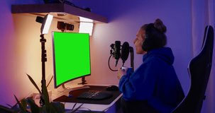 GREEN SCREEN CHORMA KEY Caucasian teen girl recording a podcast or doing live stream from home 4K UHD RAW graded footage