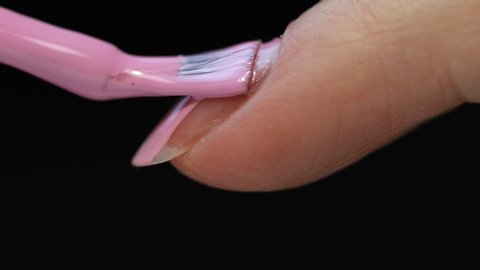 Manicure nail paint. Master applies gel polish on nails  in manicure salon. Nail polish.