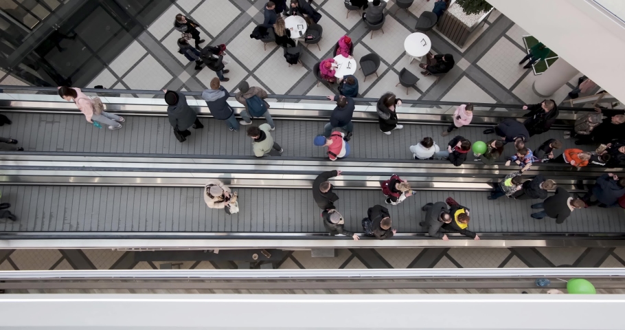 crowd of people on an escalator in a large multi-storey layered shopping center. view from above Royalty-Free Stock Footage #1047044662