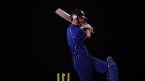 4K: Cricket Batsman bowled out - Wicket. Black background. Dressed in blue. Stock Video Clip Footage
