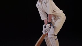 4K: Cricket Batsman hitting the ball - Cover drive. Black background. Dressed in white. Stock Video Clip Footage