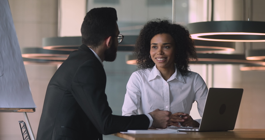 Confident young middle eastern ethnicity businessman shaking hands, coming to agreement with happy African American businesswoman after project negotiations at brainstorming meeting in office. Royalty-Free Stock Footage #1047051007