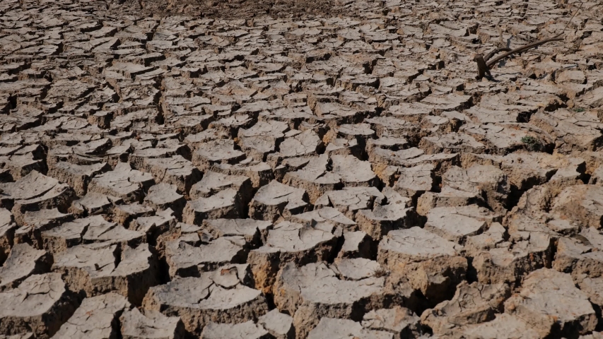 Drought-cracked soils, dry-cracked lakes, drought soil at river bottom. Ecosystems caused by climate change. Drought concept.dried and cracked soils. thirst and desertification. Royalty-Free Stock Footage #1047054562