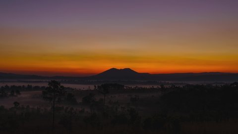 4K timelapse sunrise. Beautiful sunrise in savanah meahow green hills glowing,Shine silhouette tree colorful warm above mountain at Thung Salaeng Luang National Park, Phetchabun Province,Thailand. 