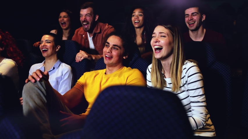 Group of cheerful people laughing while watching movie in cinema. Royalty-Free Stock Footage #1047062884