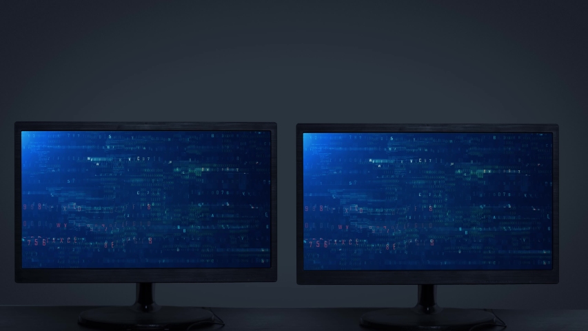 Two computer monitor displaying program security hacking code data. Shot in 4k resolution