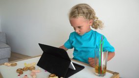 Serious office worker child make mistake sitting by tablet computer. Girl pretending to be business woman. Gimbal motion shot.