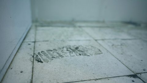 Close up of dirty footprint on dust floor in the unused house. Shot in 4k resolution