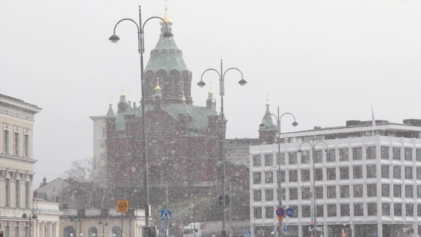 Snowing in winter Helsinki, Finland. View of Uspenski Cathedral  from market Square in february day